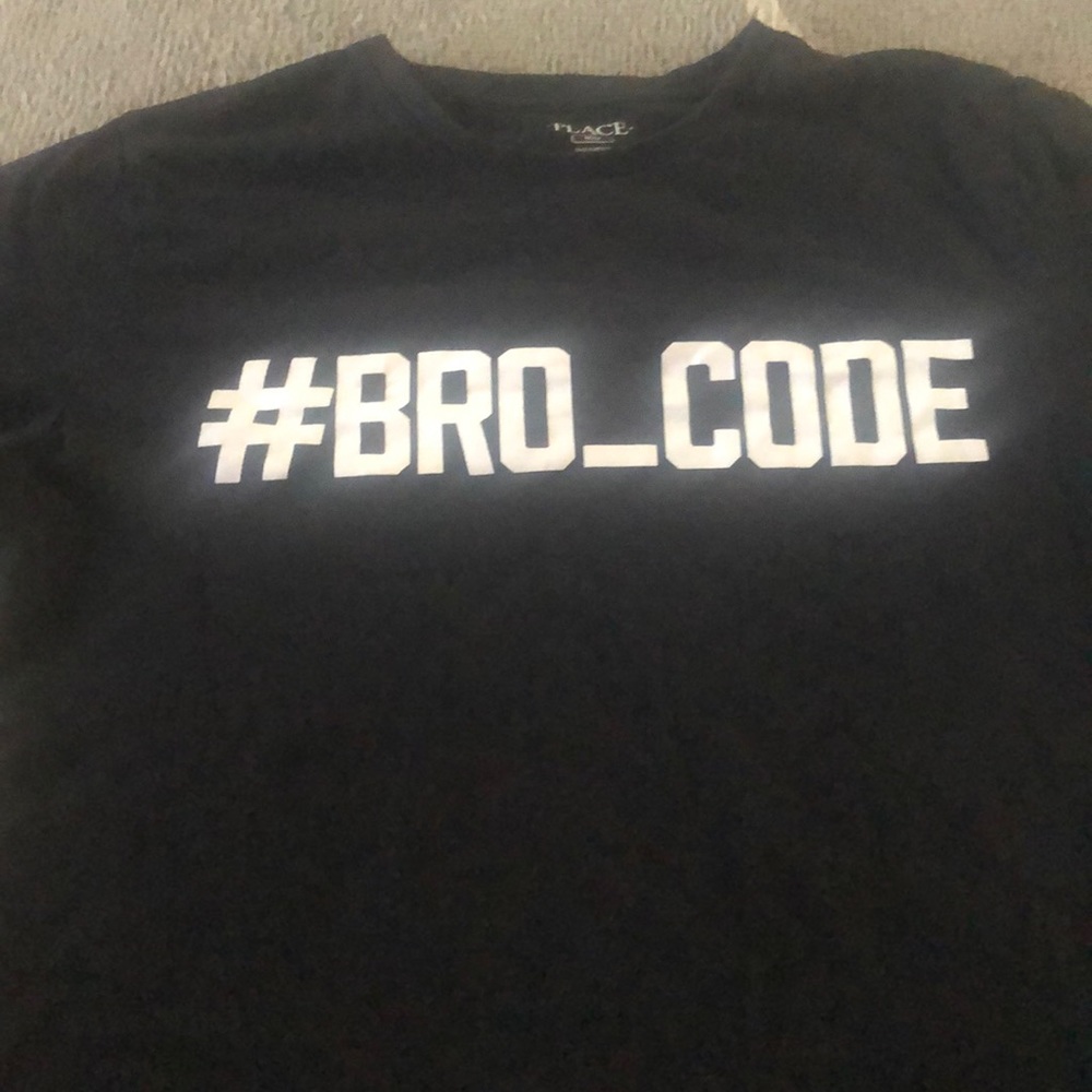Black tee shirt with white writing